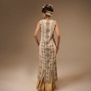 Woman wearing a traditional embroidered dress with a plain background