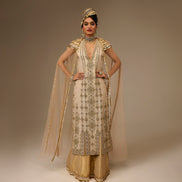 Woman in traditional embroidered outfit with a plain background