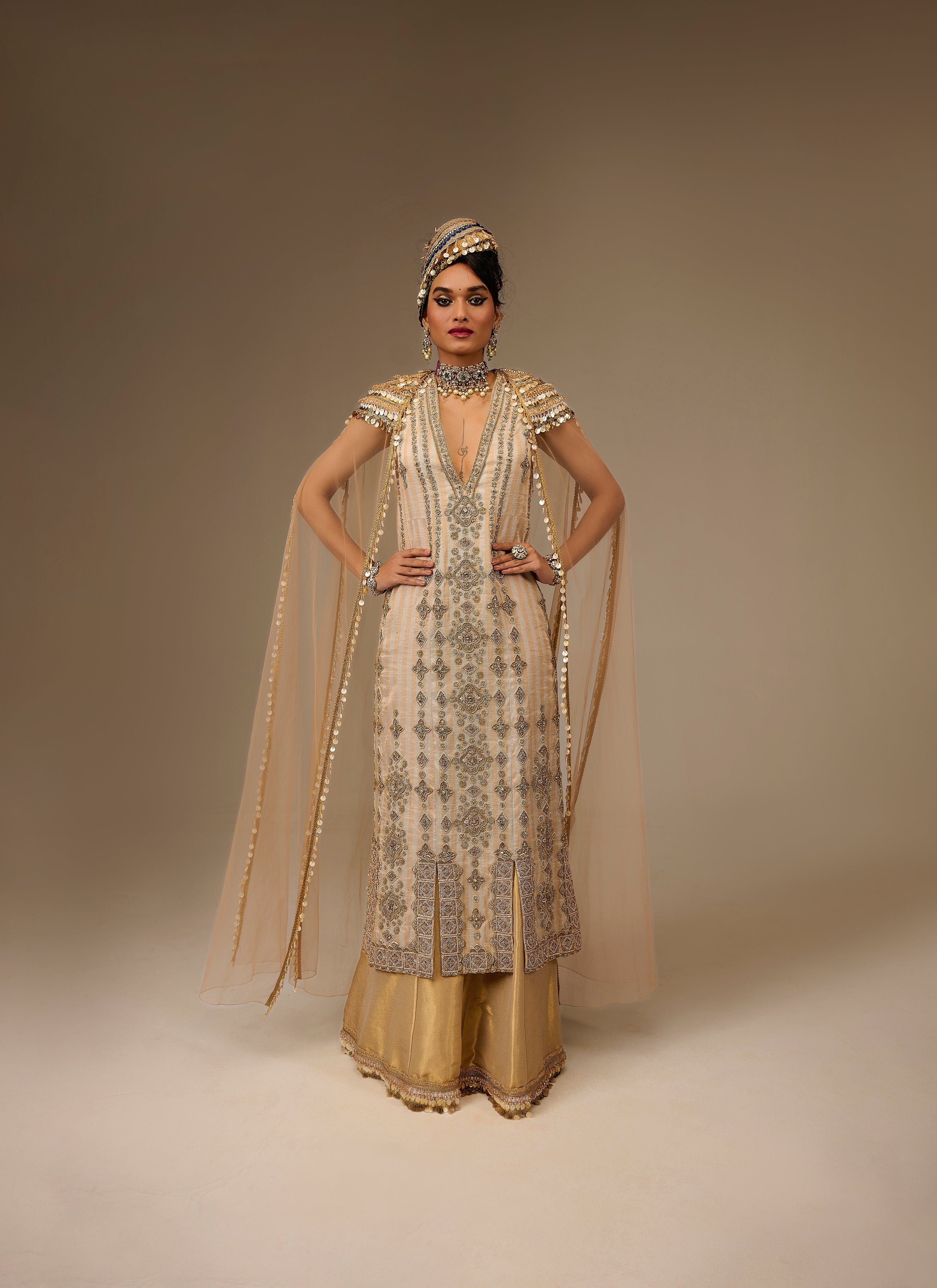 Woman in traditional embroidered outfit with a plain background