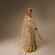 Woman in traditional attire with a plain background