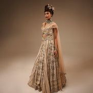 Woman wearing a traditional outfit with intricate patterns on a brown background