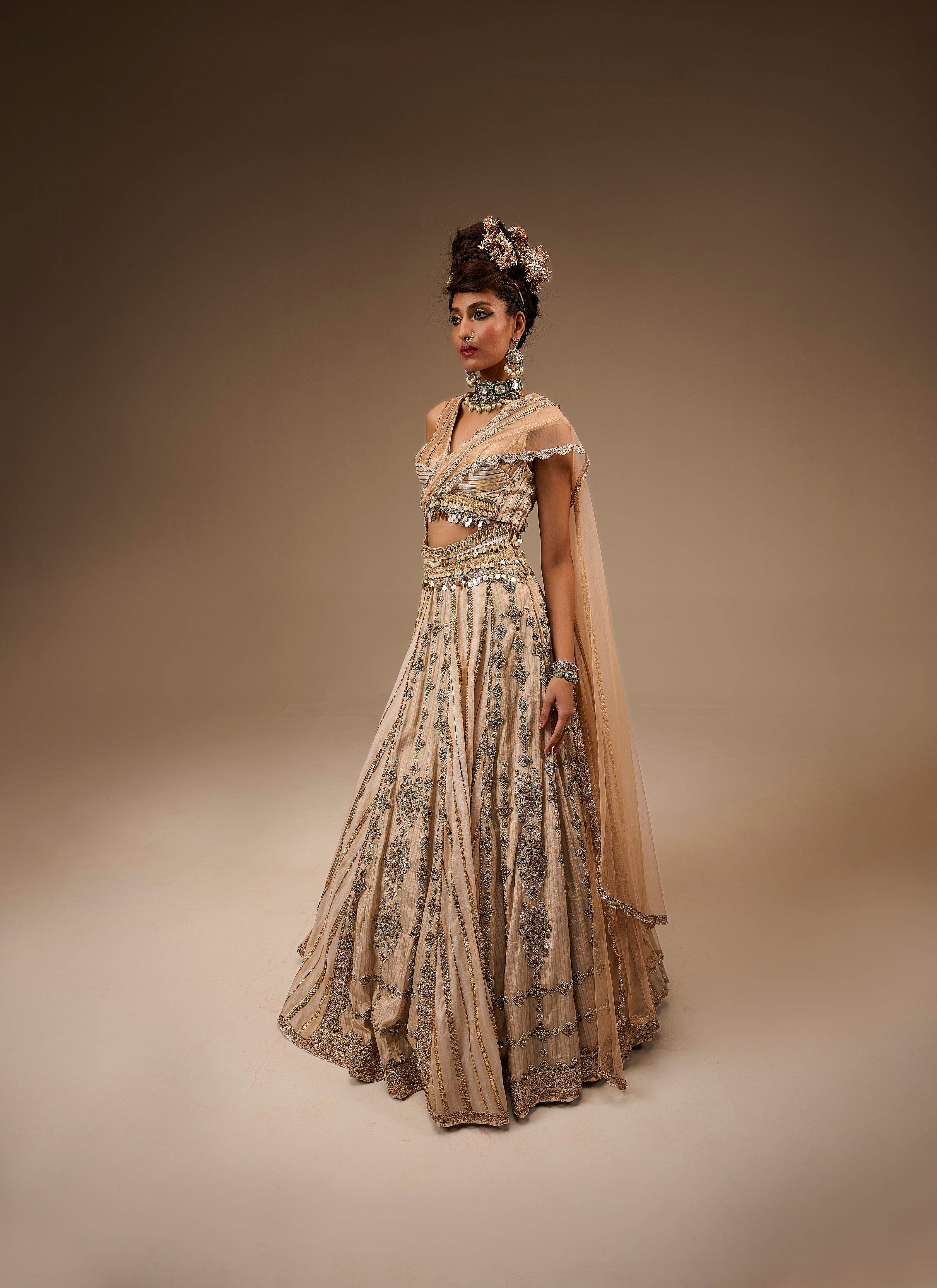 Woman wearing a traditional outfit with intricate patterns on a brown background