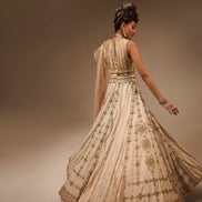 Woman in an ornate dress with a brown background