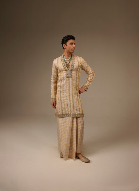 Person wearing a traditional outfit with intricate patterns on a plain background