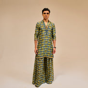 Man wearing a patterned outfit on a beige background