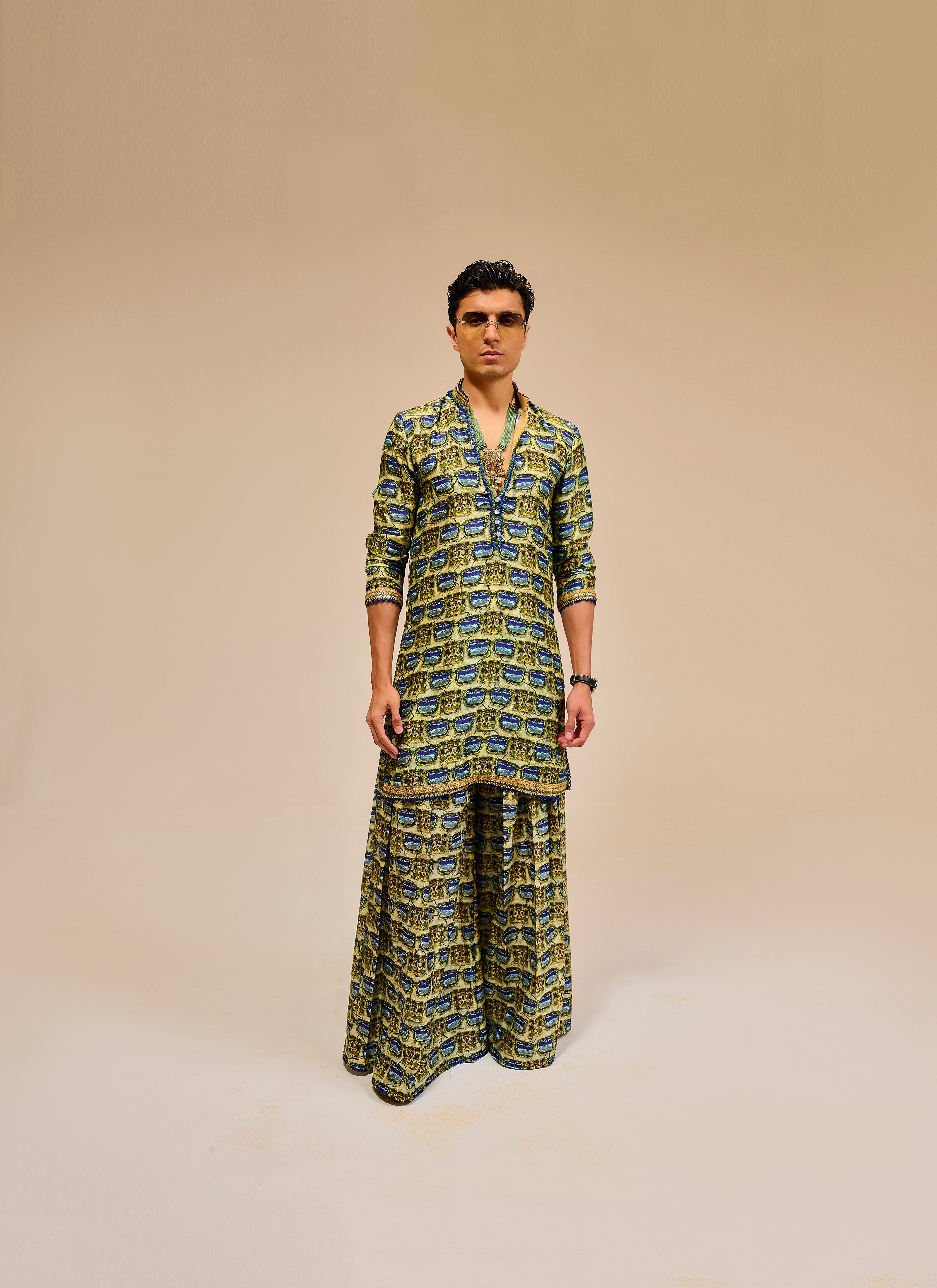 Man wearing a patterned outfit on a beige background