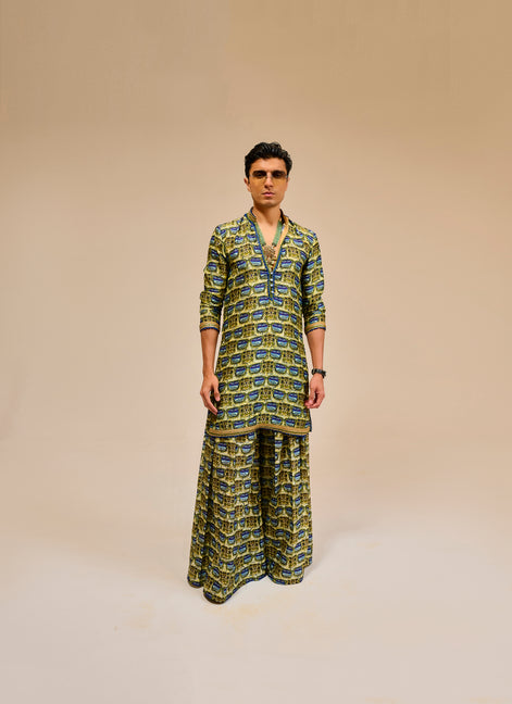 Man wearing a patterned outfit on a beige background
