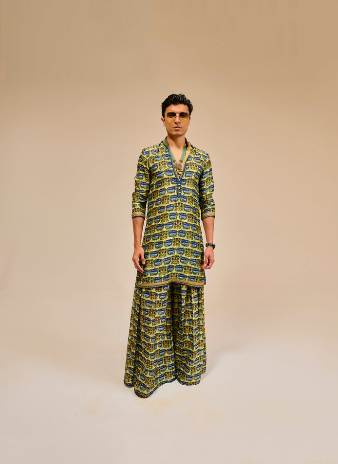 Man wearing a patterned outfit on a beige background