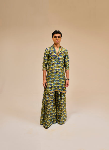 Man wearing a patterned outfit on a beige background