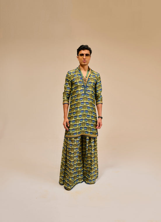 Man wearing a patterned outfit on a beige background