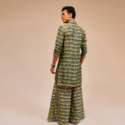 Man wearing a patterned outfit on a beige background