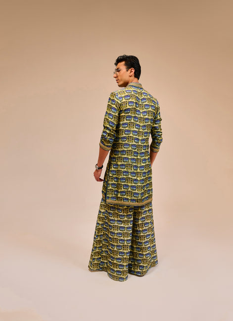 Man wearing a patterned outfit on a beige background
