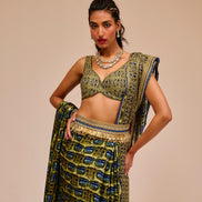 Woman wearing a traditional outfit with a patterned top and skirt on a beige background
