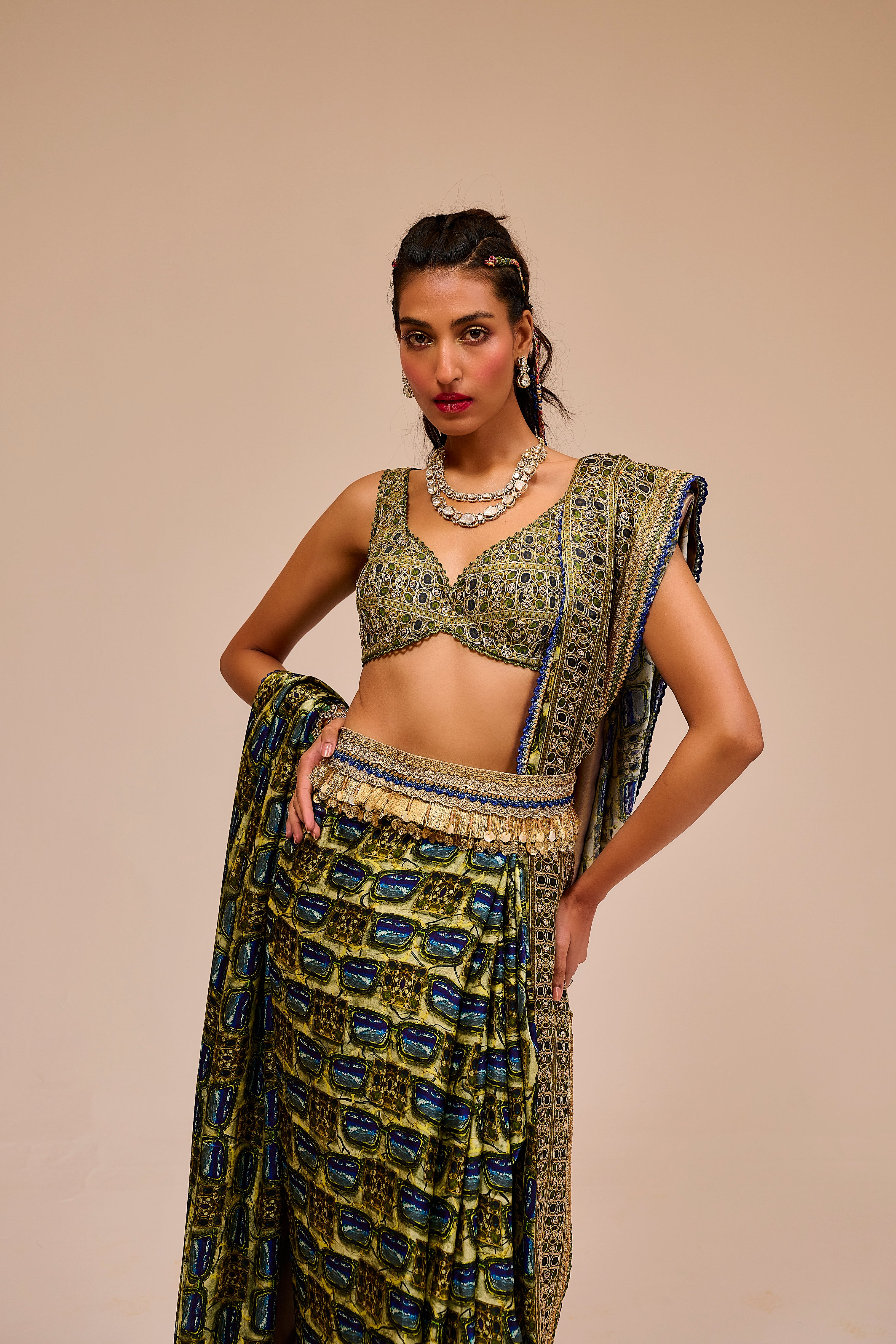 Woman wearing a traditional outfit with a patterned top and skirt on a beige background