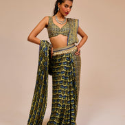 Woman wearing a green patterned outfit against a beige background