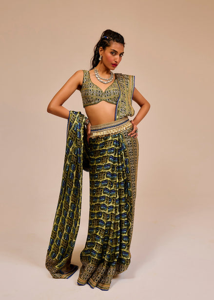 Woman wearing a green patterned outfit against a beige background