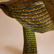 Decorative fabric with intricate patterns and embroidery on a beige background