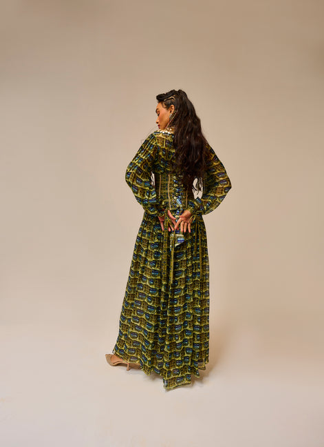 Woman wearing a green patterned dress against a beige background