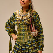 Woman wearing a patterned dress with a beige background