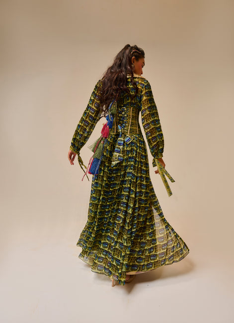 Woman wearing a long, patterned dress against a beige background