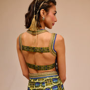 Woman wearing a colorful dress with a patterned design on a beige background