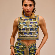 Woman wearing a traditional outfit with intricate patterns on a beige background