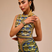 Woman wearing a traditional outfit with intricate designs on a beige background