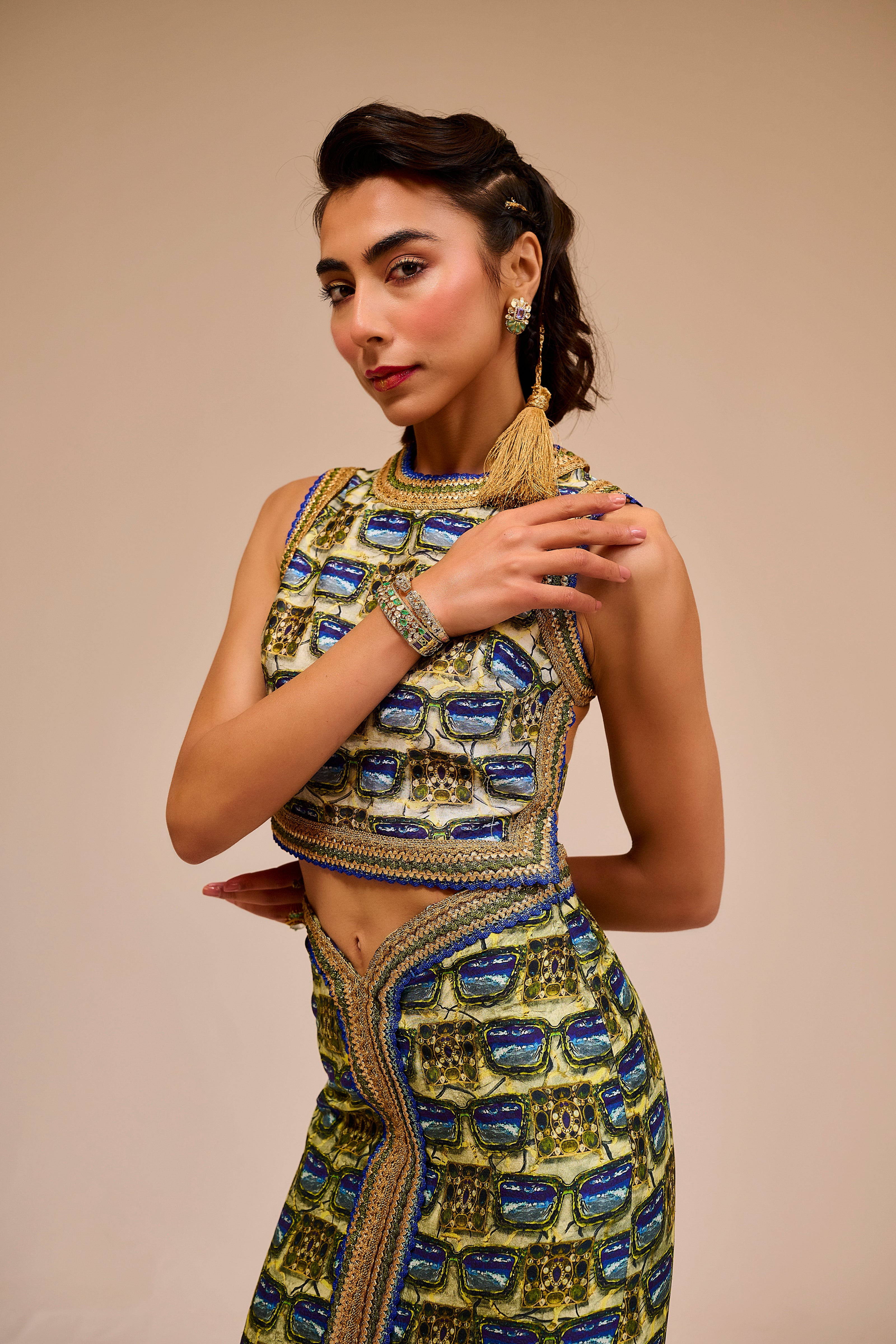 Woman wearing a traditional outfit with intricate designs on a beige background