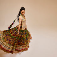 Woman in traditional multicolored outfit with a plain background