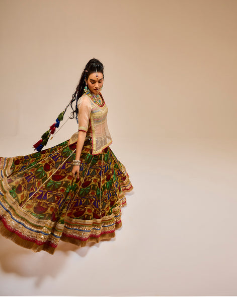 Woman in traditional multicolored outfit with a plain background