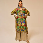 Woman wearing a colorful patterned outfit on a beige background