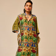 Woman wearing a colorful patterned outfit against a beige background
