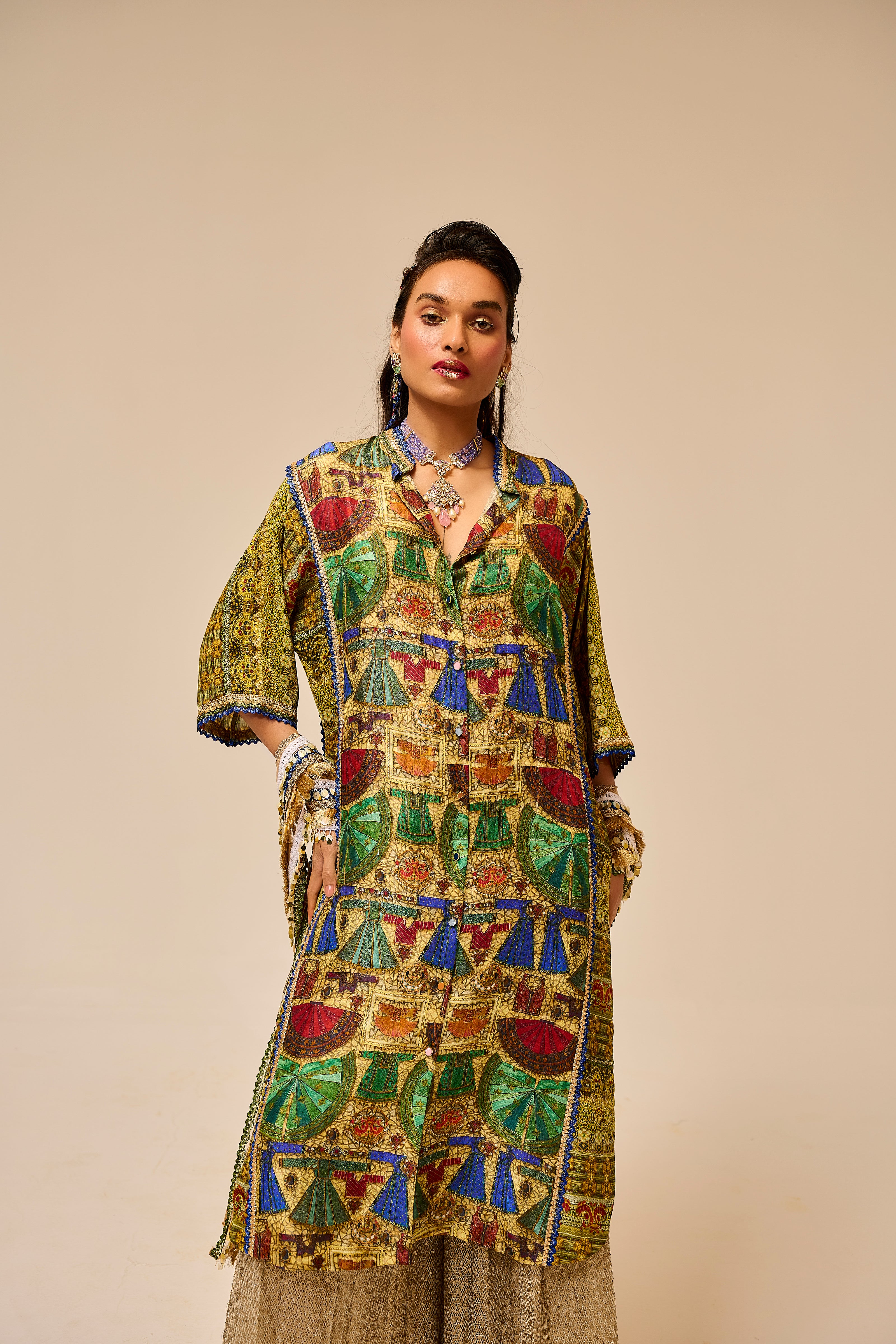 Woman wearing a colorful patterned outfit against a beige background