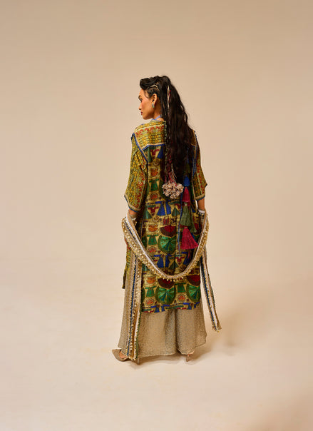 Traditional outfit with intricate patterns on a plain background