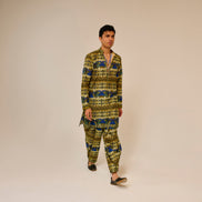 Man wearing a patterned outfit on a plain background