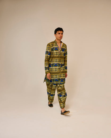 Man wearing a patterned outfit on a plain background