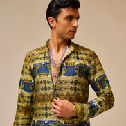 Man wearing a patterned shirt against a beige background