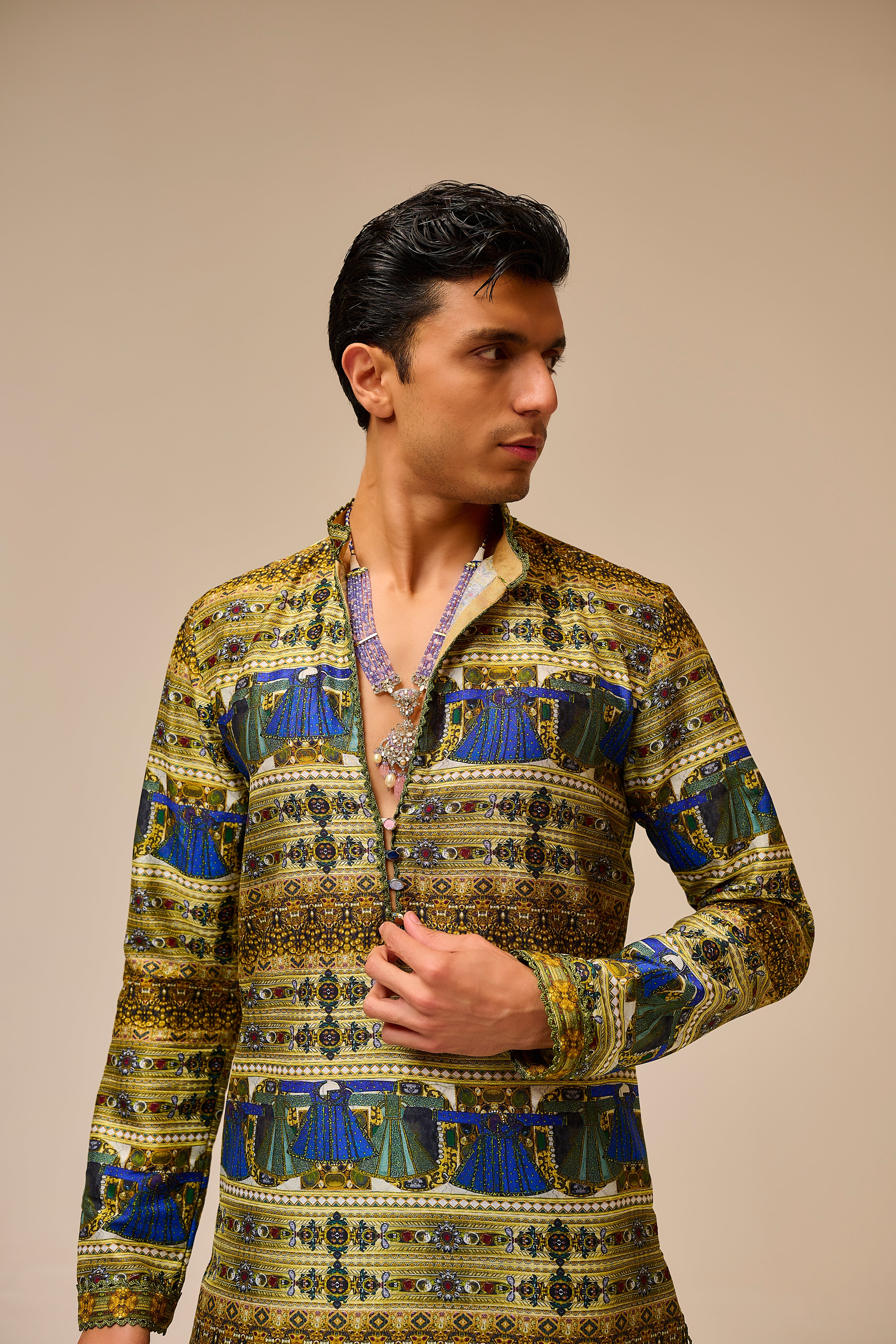 Man wearing a patterned shirt against a beige background
