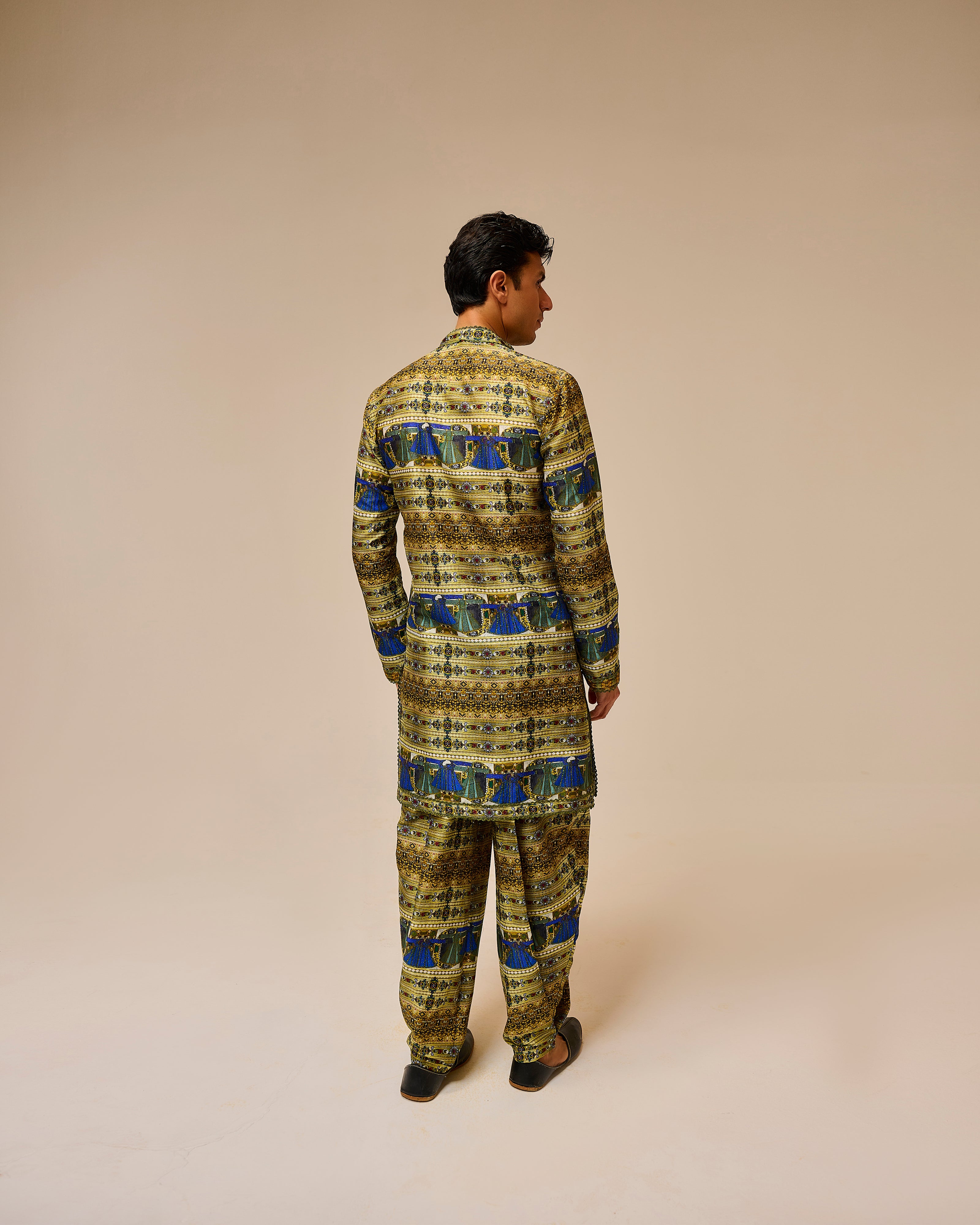 Person wearing a patterned outfit on a beige background
