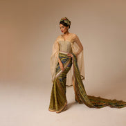 Woman in a traditional outfit with a long, flowing garment on a beige background