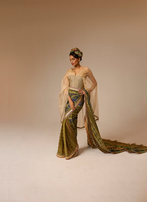 Woman in a traditional outfit with a long, flowing garment on a beige background