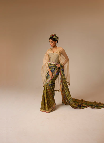Woman in a traditional outfit with a long, flowing garment on a beige background
