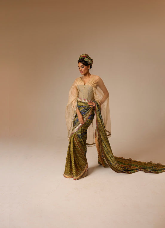 Woman in a traditional outfit with a long, flowing garment on a beige background