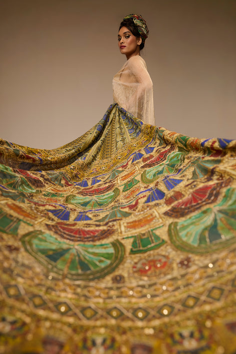Woman with a colorful, patterned fabric draped over her shoulders against a neutral background