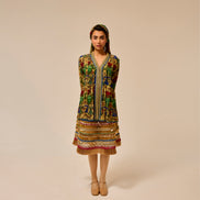 Woman wearing a colorful patterned dress on a beige background