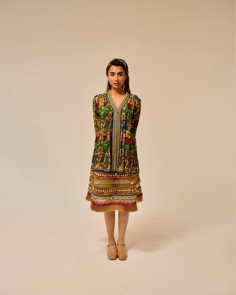 Woman wearing a colorful patterned dress on a beige background