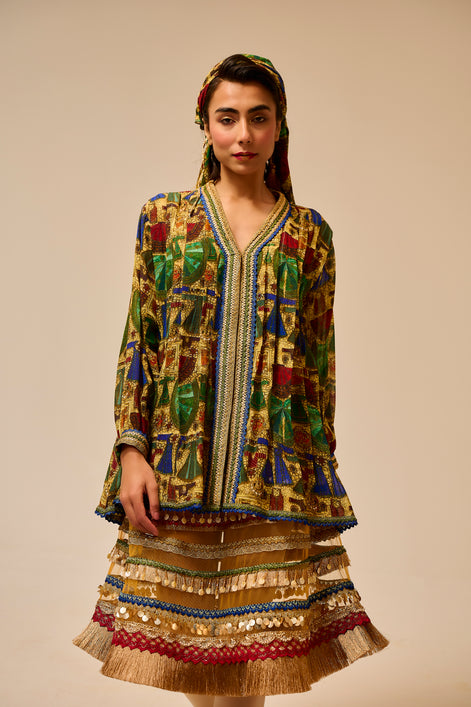 Woman wearing a colorful traditional outfit with a patterned jacket and skirt on a beige background