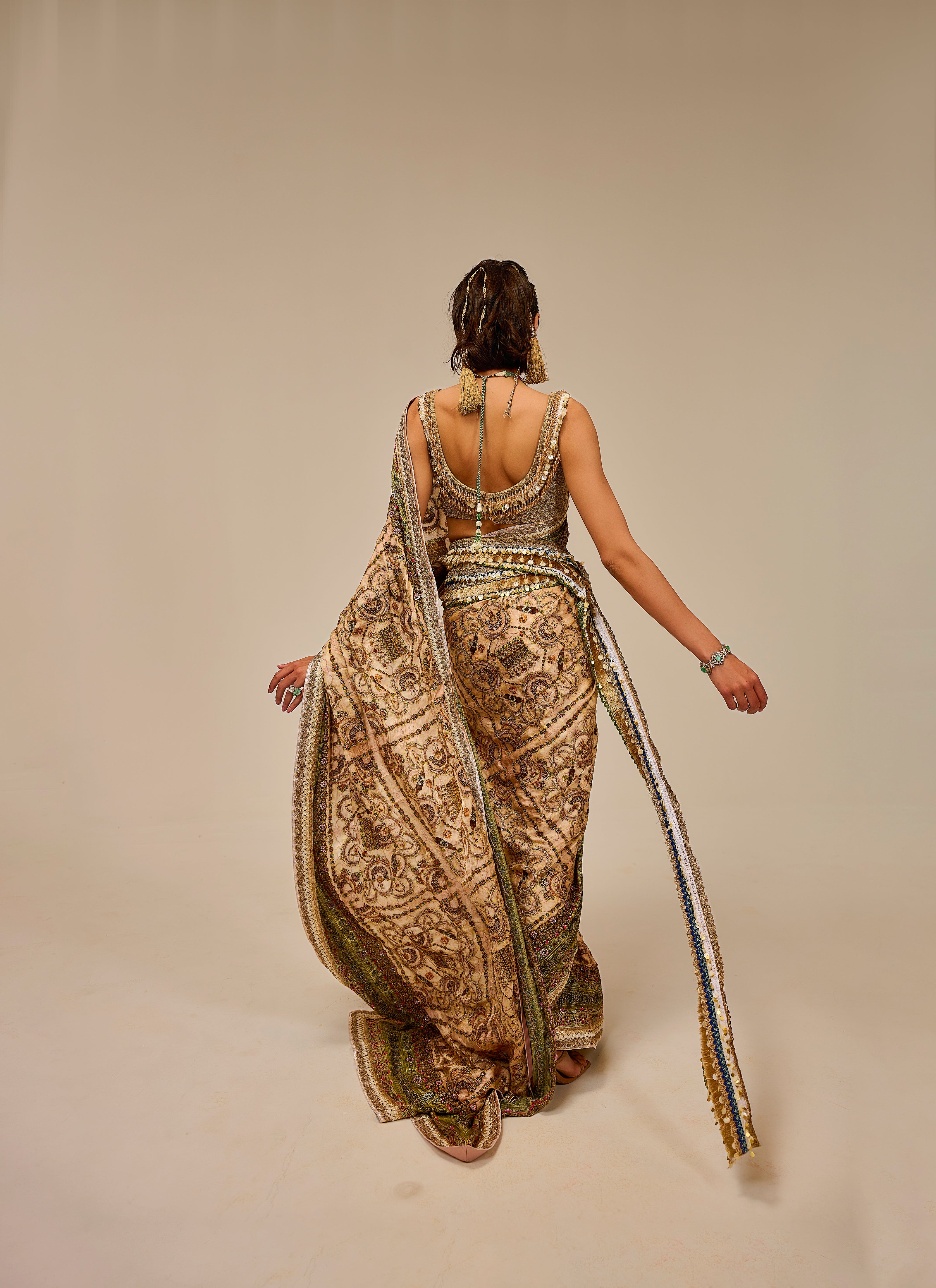 Woman wearing a long, patterned dress with a plain background