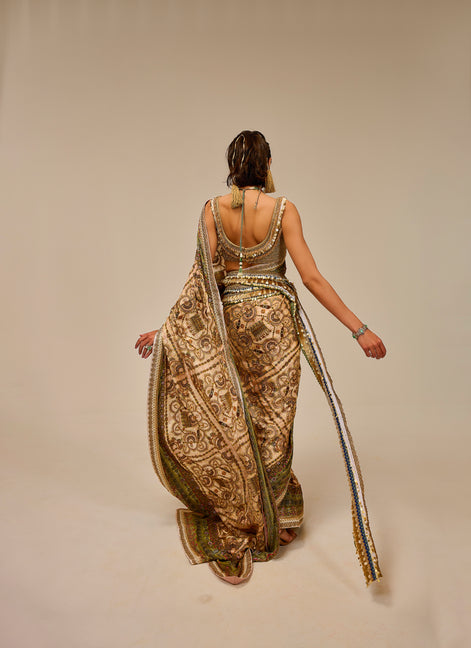 Woman wearing a long, patterned dress with a plain background