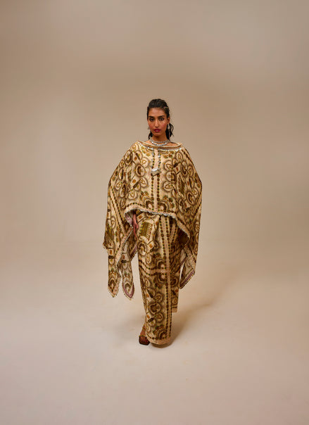 Woman wearing a patterned outfit on a beige background